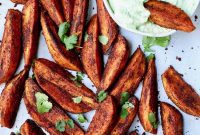 Smoky Chipotle Sweet Potato Wedges with Zesty Avocado Cilantro Crema