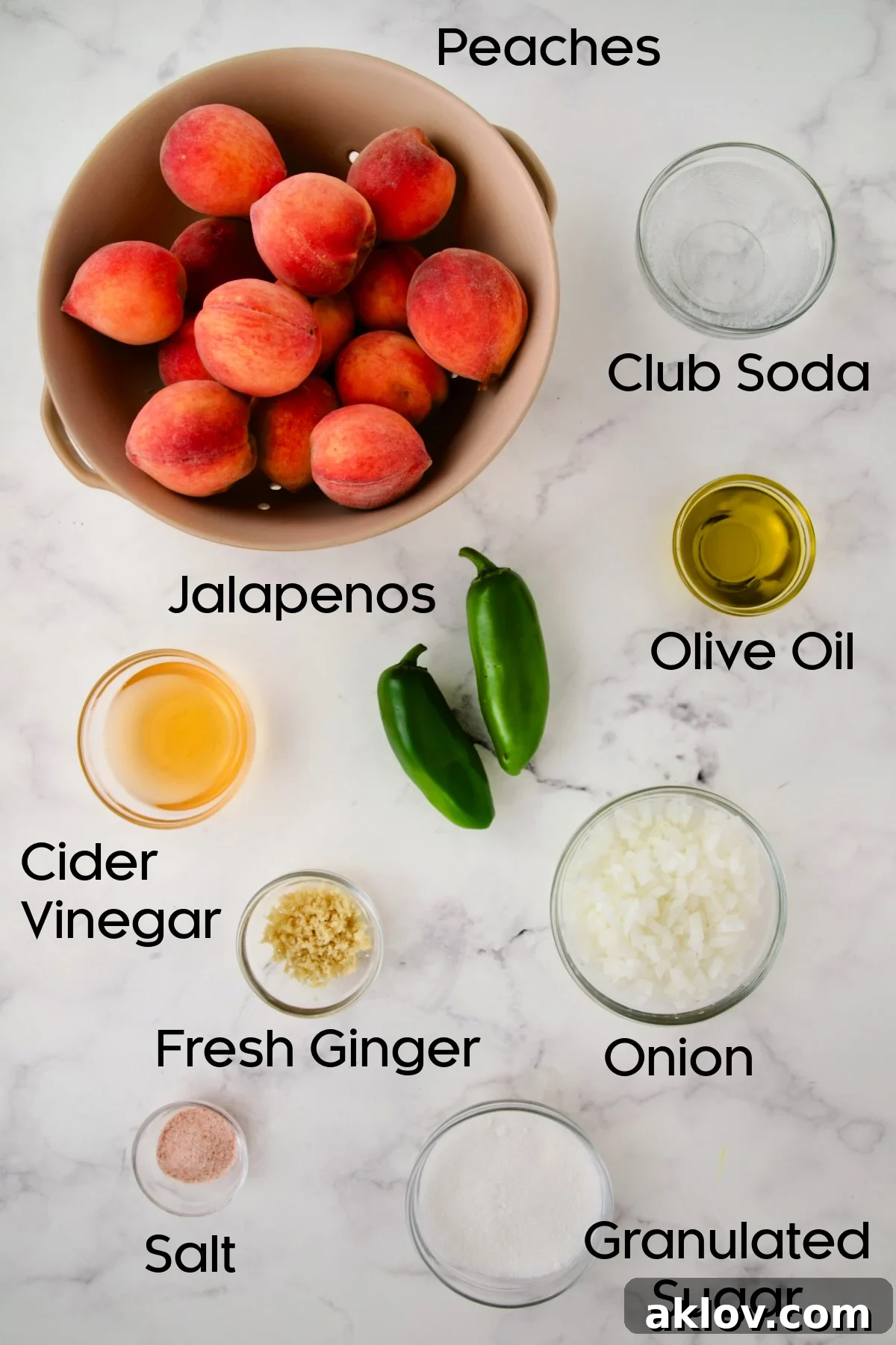 Various fresh ingredients for Peach Jalapeno Chutney, including peeled peaches, sliced jalapeños, red onion, and fresh ginger, neatly arranged in glass bowls.