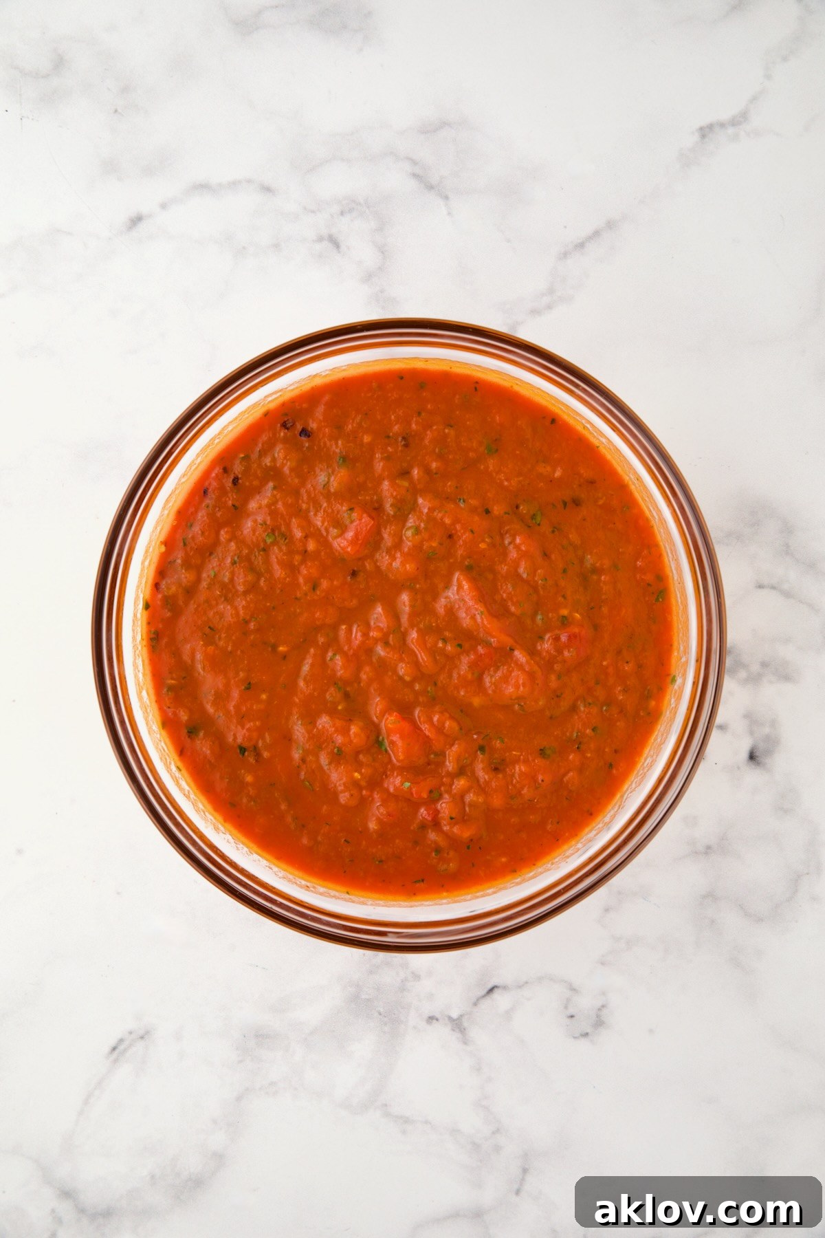 Marinara sauce in glass bowl.