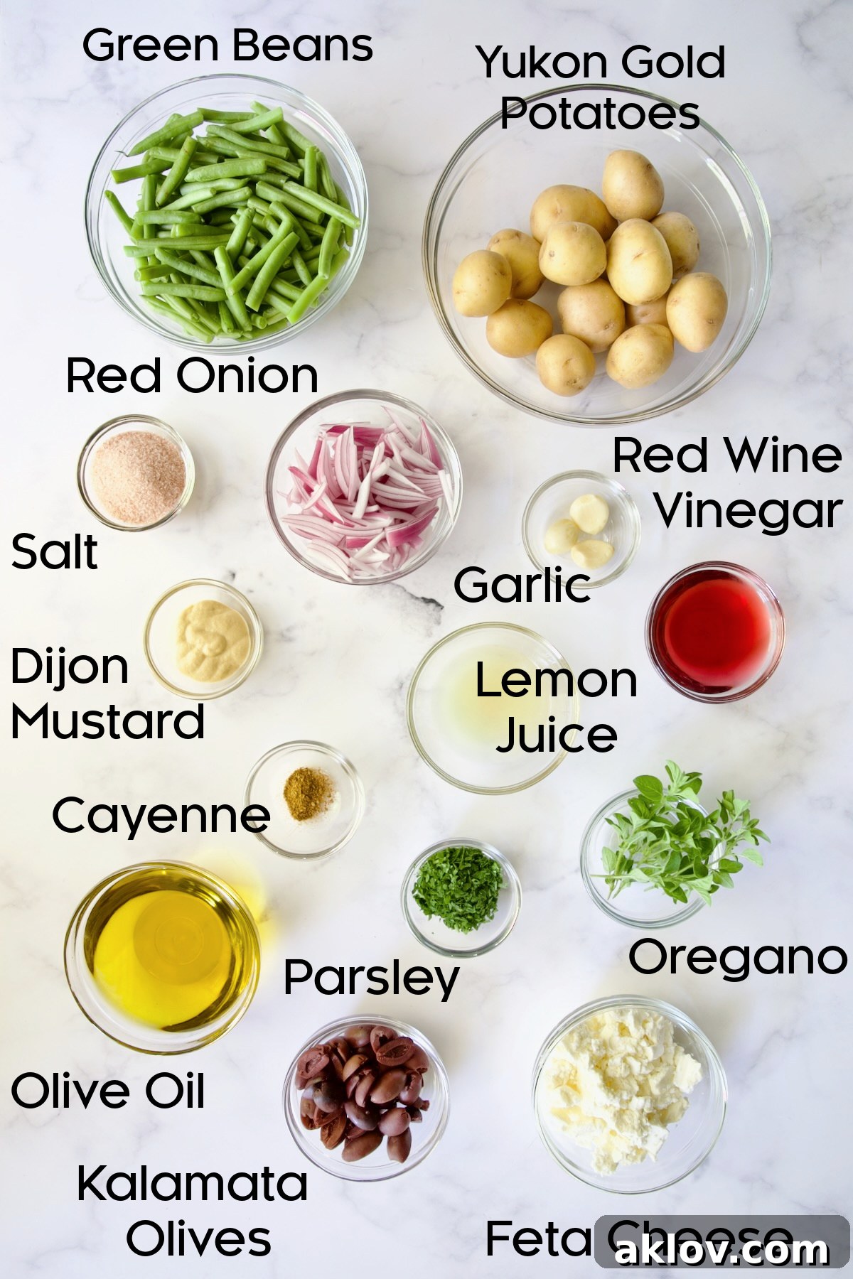 A collection of fresh, vibrant ingredients for Potato Green Bean Salad, neatly arranged in glass bowls, ready for preparation.
