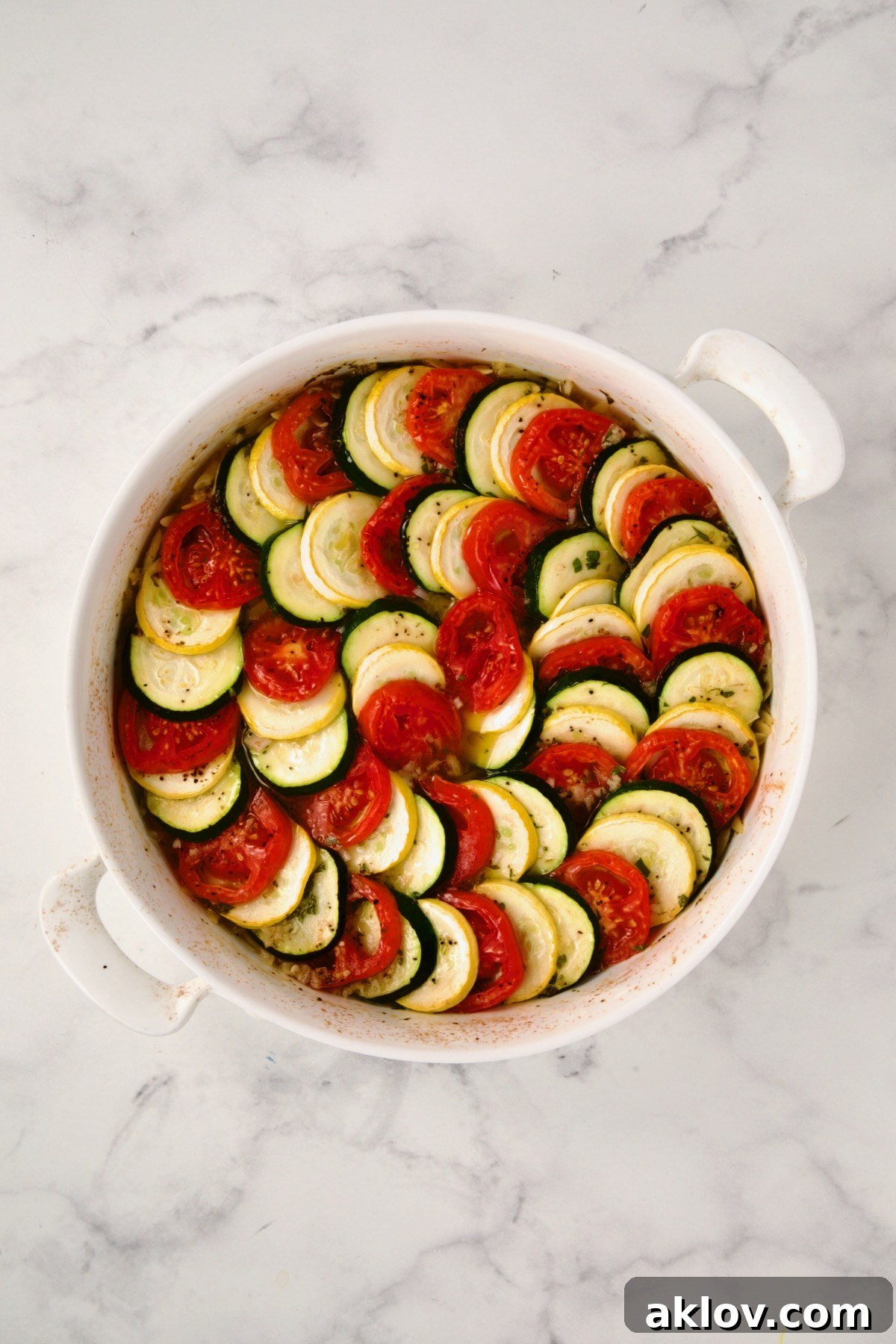 The Orzo Vegetable Tian partially baked, showing softened vegetables and cooked orzo underneath.