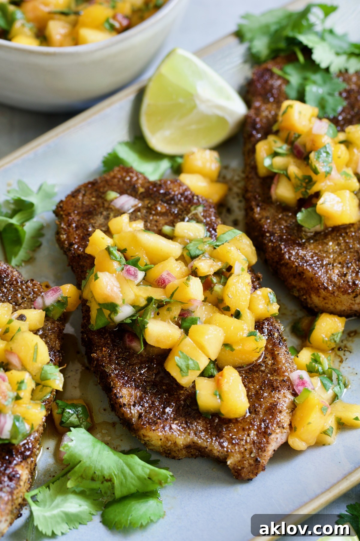 Pork Chops with Peach Salsa on oval gray platter.