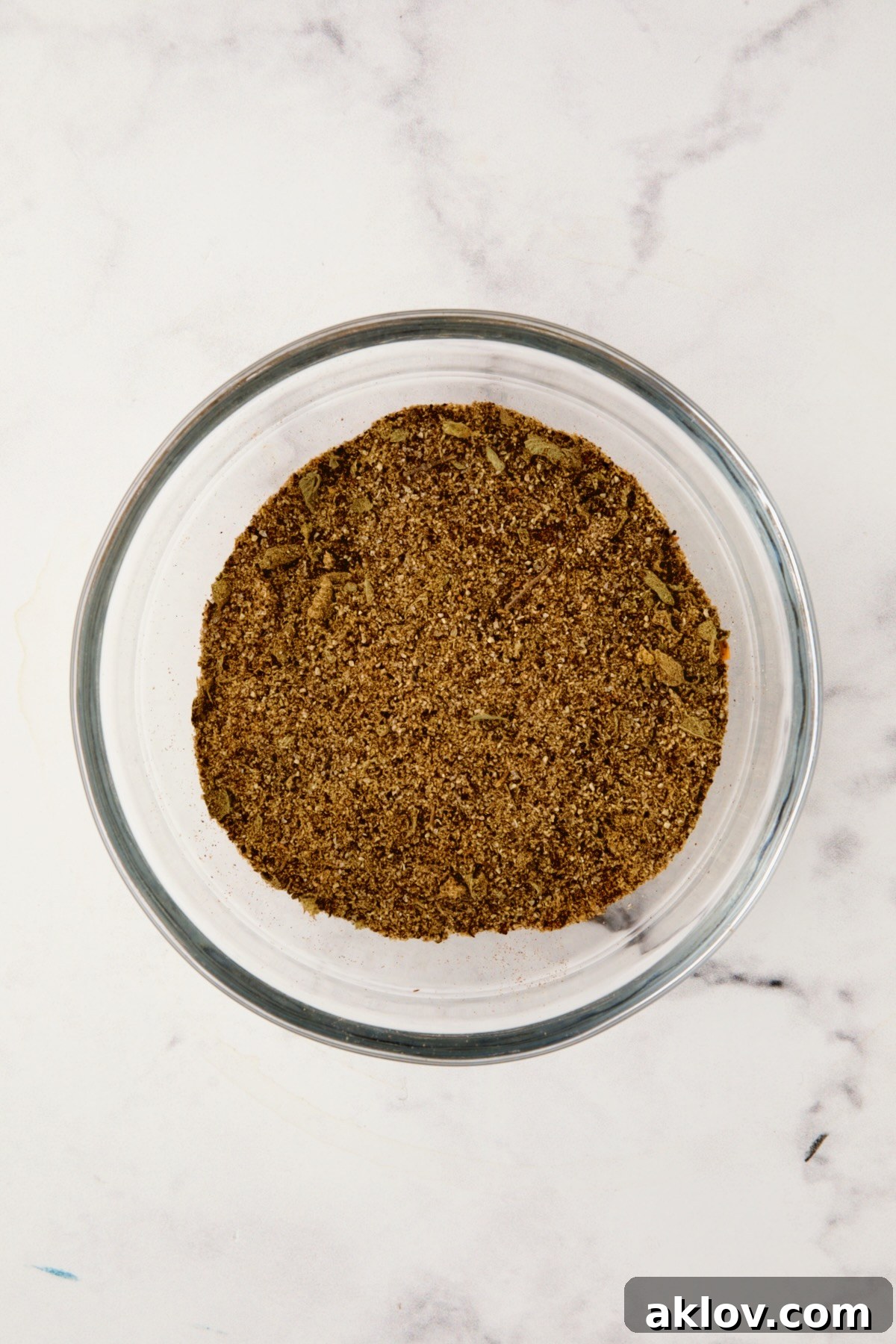 Spices for spice rub in glass bowl after being stirred together.