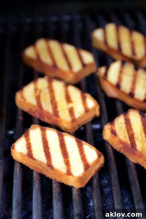Photo of grilled pound cake slices on grill.