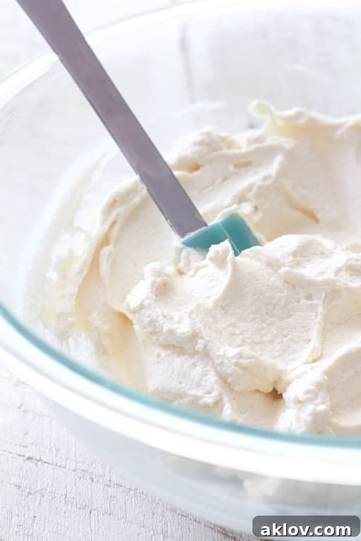 Photo of mascarpone cream in glass mixing bowl.
