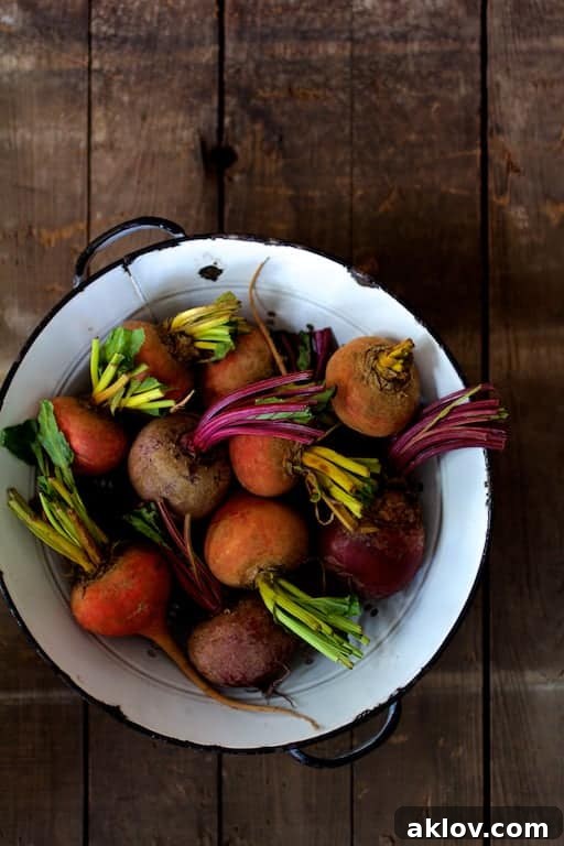 Fan-Cut Roasted Beets with Zesty Dill Dressing 4 Photo of whole raw beets in antique white colander on wooden background.