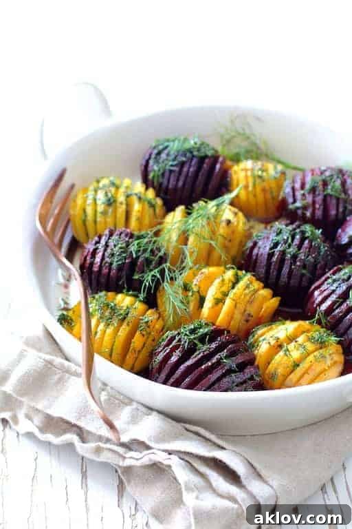 Fan-Cut Roasted Beets with Zesty Dill Dressing 9 Roasted Hasselback Beets with Dill Dressing in white dish garnished with fresh dill sprigs.