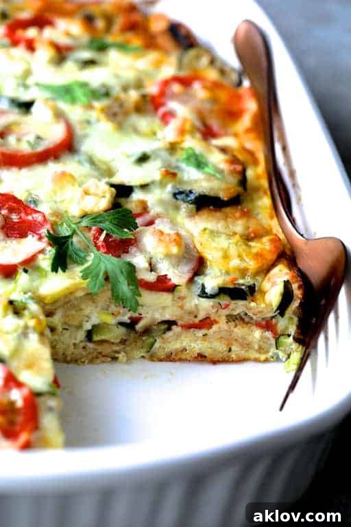 Photo of Four Cheese Strata with Zucchini and Tomatoes with piece removed showing the layers.