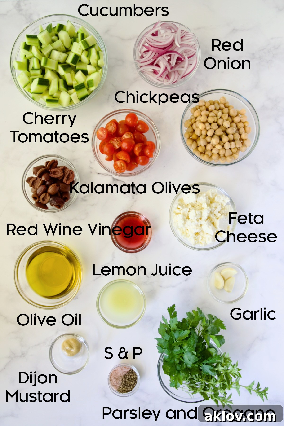 Ingredients for Greek Cucumber Salad in separate glass bowls.