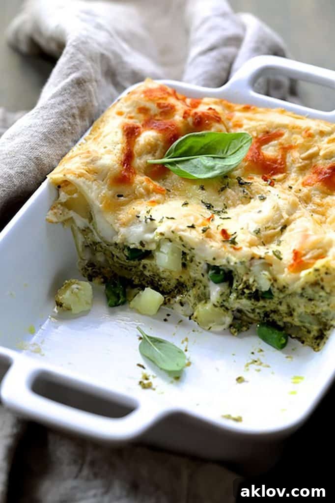 A cross-section view of Lasagna with Pesto Green Beans and Potatoes, clearly showing the beautifully layered pasta, potatoes, and green beans.