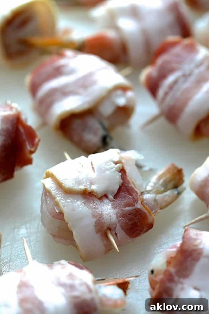 Golden Pumpkin Grits and Crispy Bacon Shrimp 7 Photo of raw bacon-wrapped shrimp, secured with toothpicks, laid out before cooking.