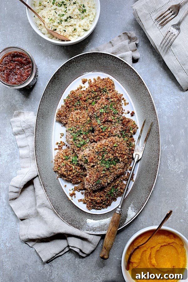 Pecan Crusted Turkey Medallions with Sweet Red Onion Marmalade 2 Photo of Pecan Crusted Turkey Cutlets with Red Onion Marmalade on gray-rimmed platter with meat fork.