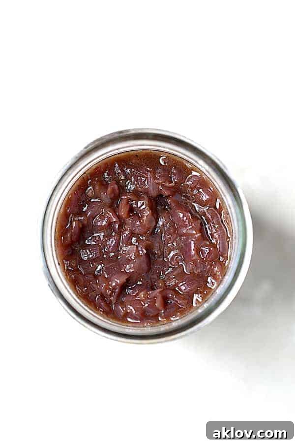 Pecan Crusted Turkey Medallions with Sweet Red Onion Marmalade 3 Photo of red onion marmalade in glass jar on white background.