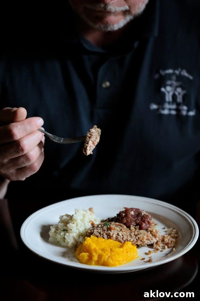 Pecan Crusted Turkey Medallions with Sweet Red Onion Marmalade 6 Photo of diner enjoying the dish.