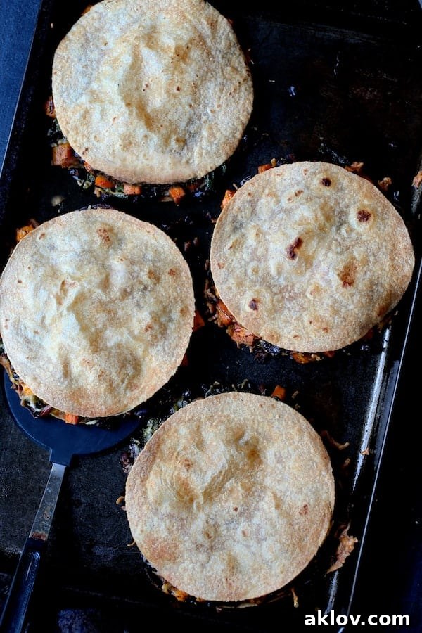 Sheet Pan Magic: Vegetarian Quesadilla Bake 4 Four assembled and baked Sheet Pan Quesadillas with Sweet Potatoes, Poblanos, and Black Beans, ready to be sliced and served.