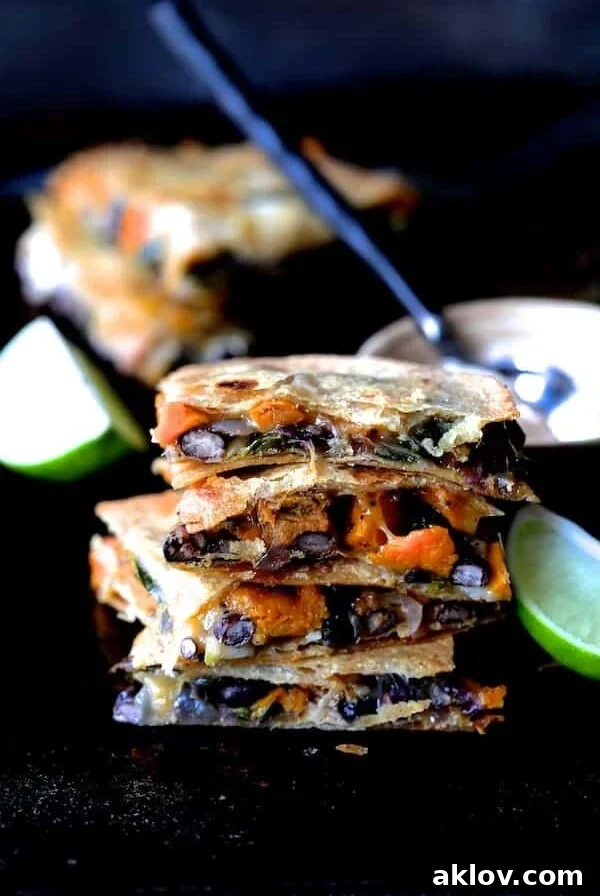 Stack of four Sheet Pan Sweet Potato, Poblano and Black Bean Quesadillas wedges.