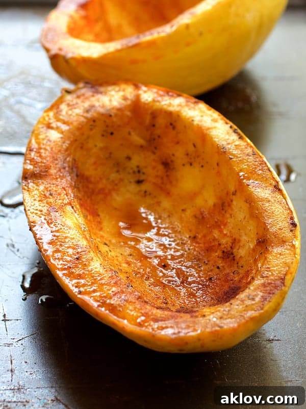 Photo of two roasted spaghetti squash halves.