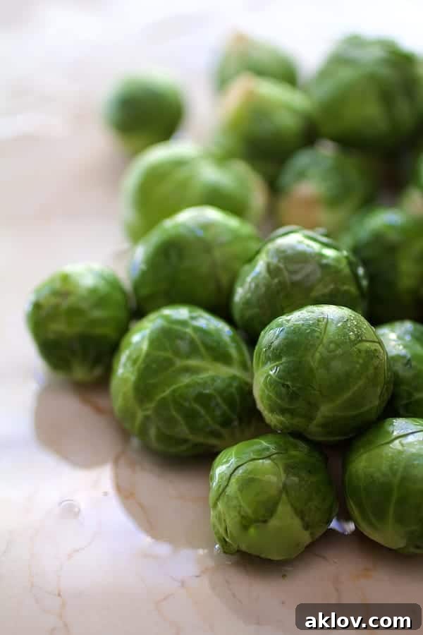 Photo of fresh, raw Brussels sprouts on a clean marble surface, highlighting their natural form before preparation.