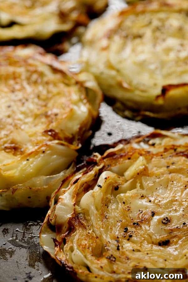 Caramelized Cabbage Steaks with Tangy Dijon Dressing 3 Close-up photo of roasted cabbage steaks on baking sheet.