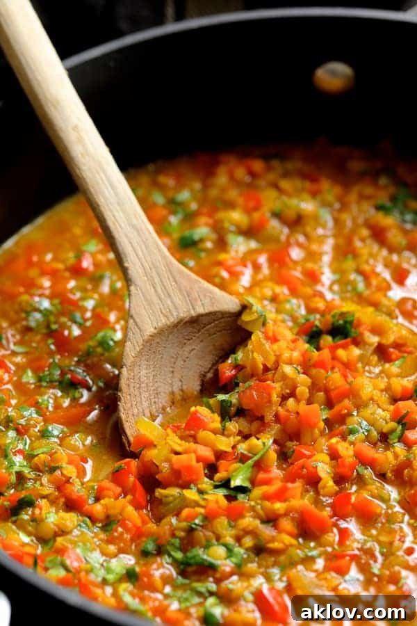 Masala-Crusted Sea Bass with Hearty Red Lentil Daal 3 Red lentils are gently stirred in a saucepan as they braise to a creamy, tender consistency, absorbing the rich curry flavors.