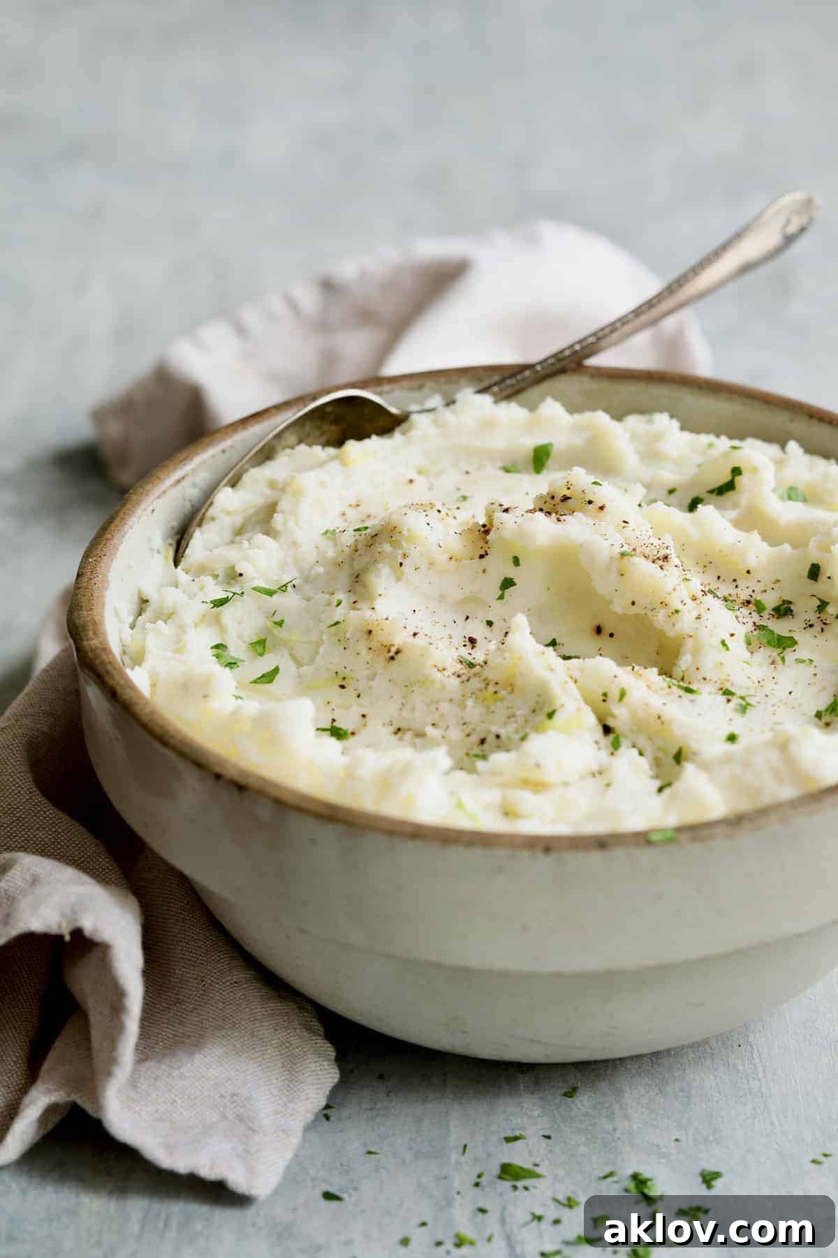 A rustic stoneware bowl brimming with creamy Colcannon, garnished with a sprig of fresh parsley and a serving spoon, inviting you to enjoy this classic Irish comfort food.