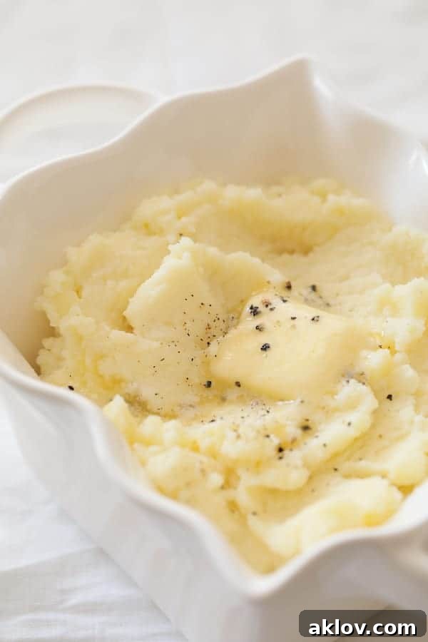 Photo of whipped Yukon gold potatoes with pat of butter melting into them.