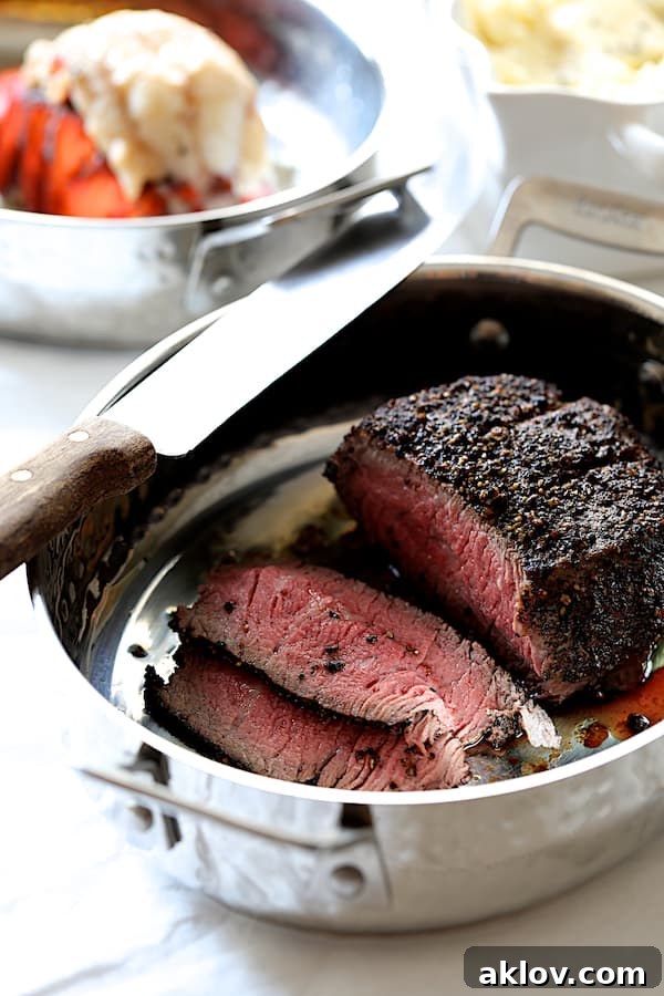 Photo of finished steak in roasting pan with some sliced.