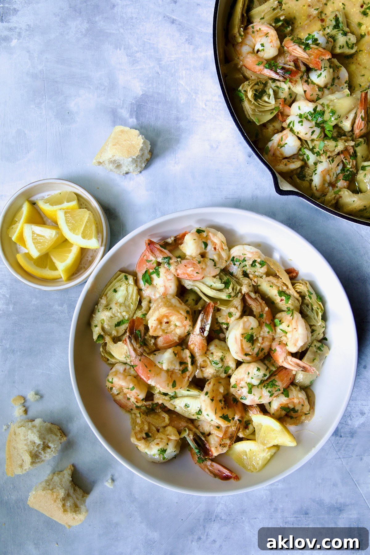 A vibrant bowl of Shrimp Scampi with Artichokes, garnished with fresh herbs, ready to be enjoyed.