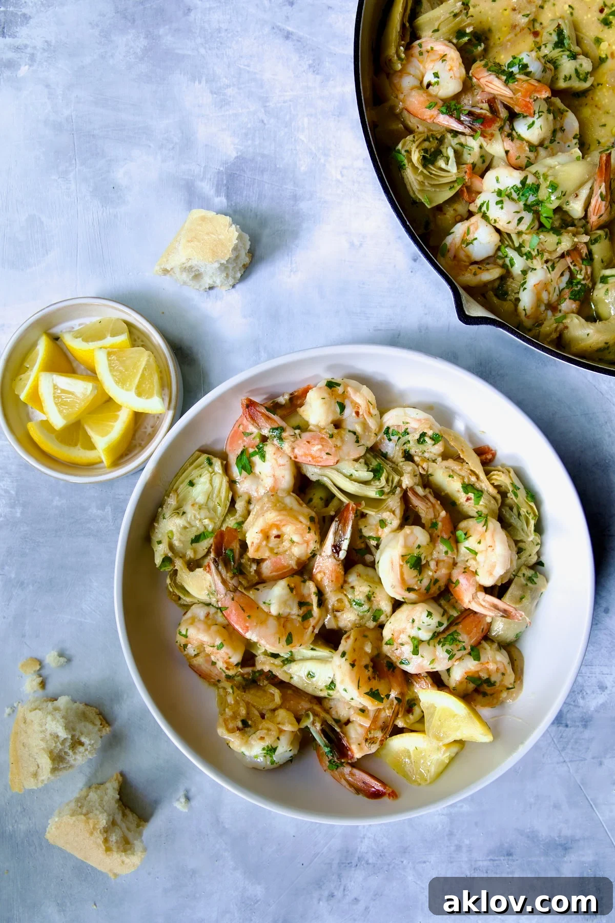 Shrimp Scampi with Artichokes in white bowl.
