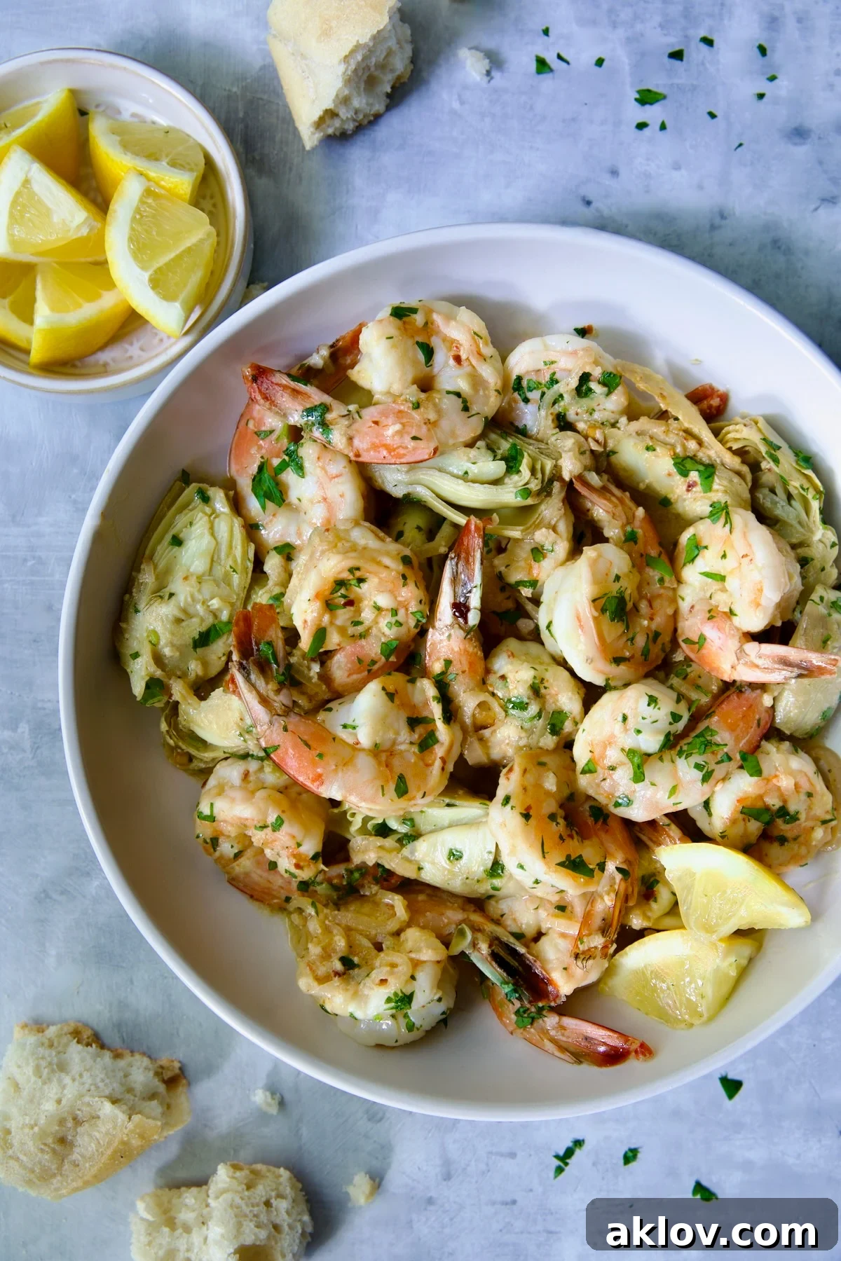 Shrimp Scampi with Artichokes in white bowl.