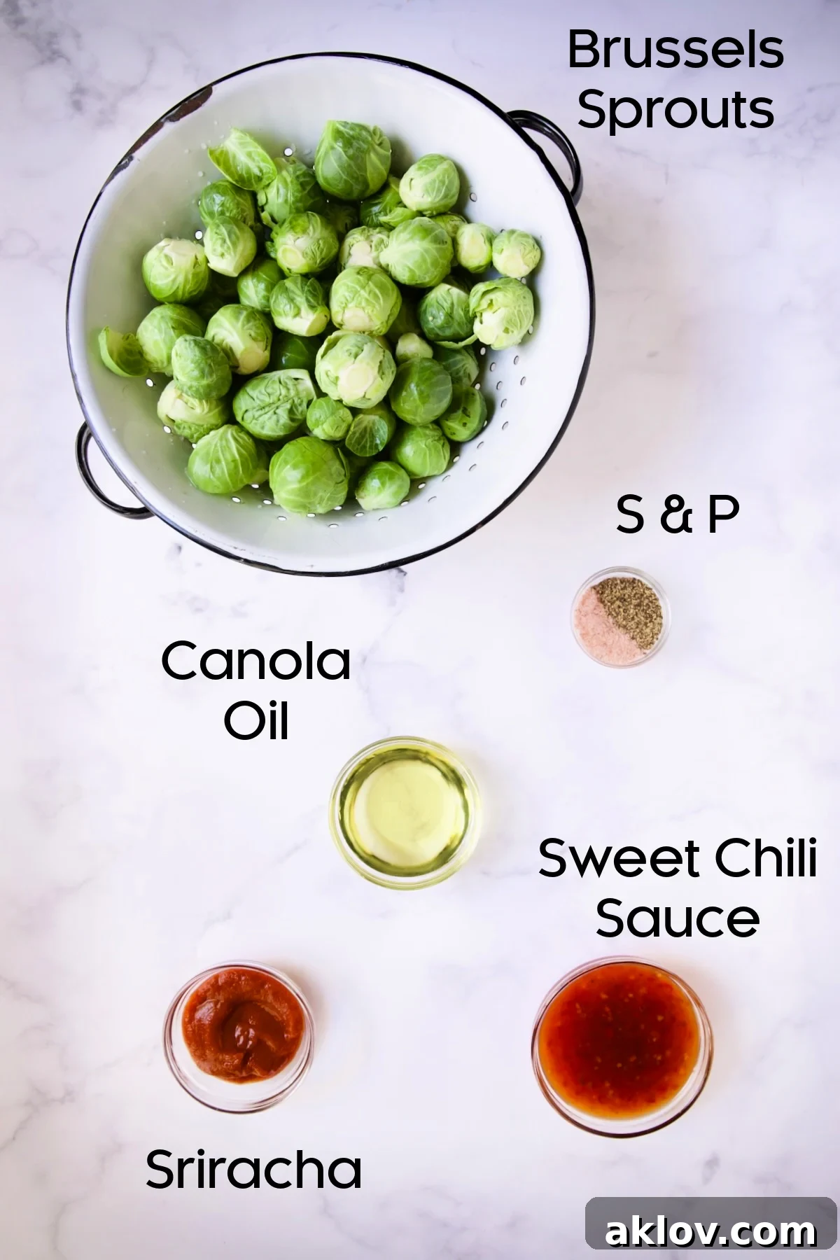 Glazed Sriracha Sweet Chili Brussels Sprouts 4 All the ingredients laid out for Sriracha Sweet Chili Roasted Brussels Sprouts, including fresh Brussels sprouts in a white colander, and Sriracha, sweet chili sauce, oil, salt, and pepper in glass bowls.