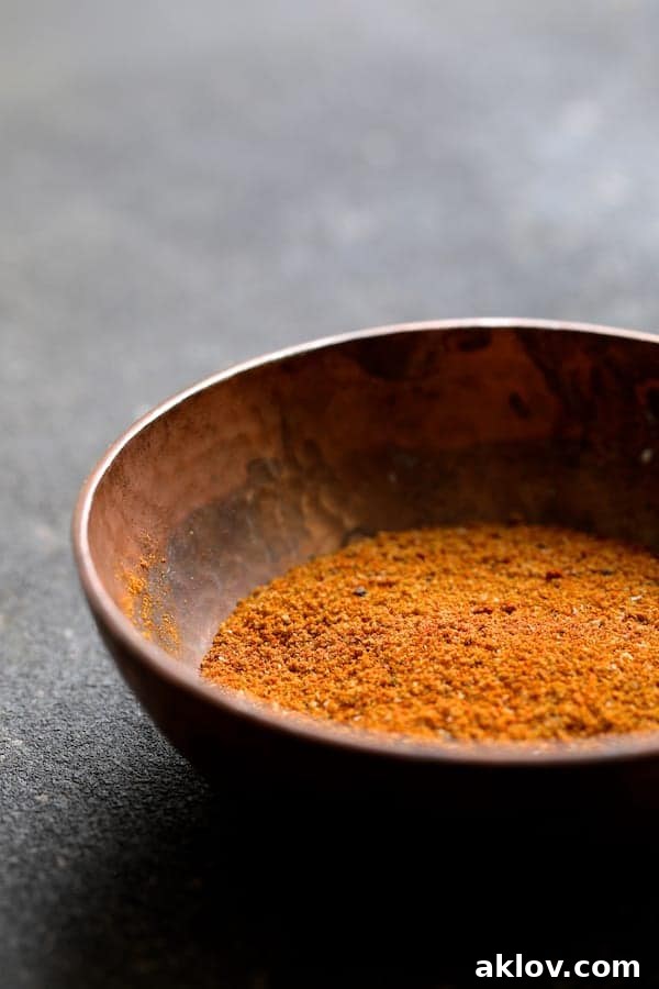 Fragrant Curry Braised Chicken Thighs 3 Photo of Madras curry powder blend in copper bowl on gray background. Essential Indian spice blend for flavorful dishes.