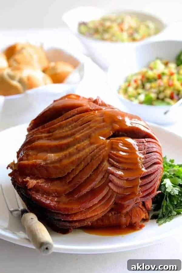 Slow Cooker Honey Ham on white platter with butcher knife nearby.
