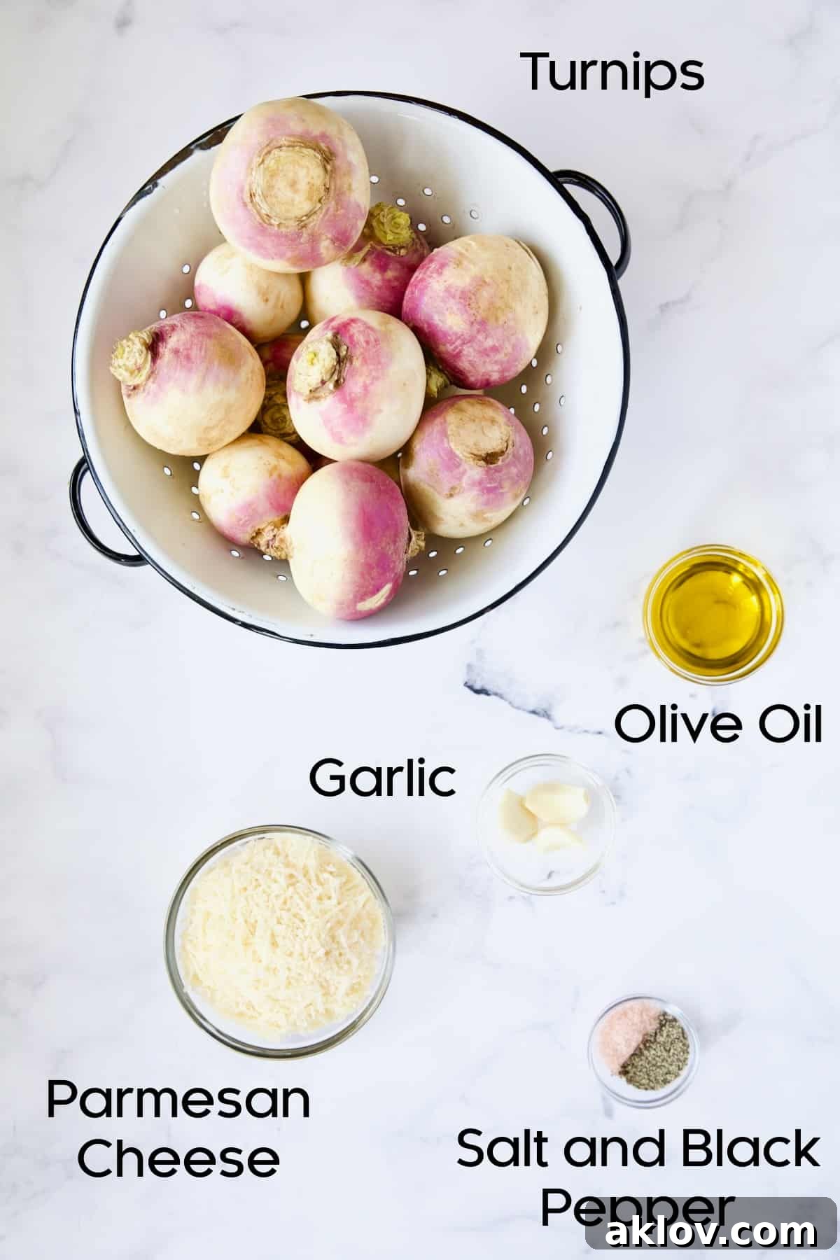 A visual display of all the fresh ingredients required for making Parmesan Crusted Crushed Turnips, including whole turnips, Parmesan cheese, garlic, and olive oil.