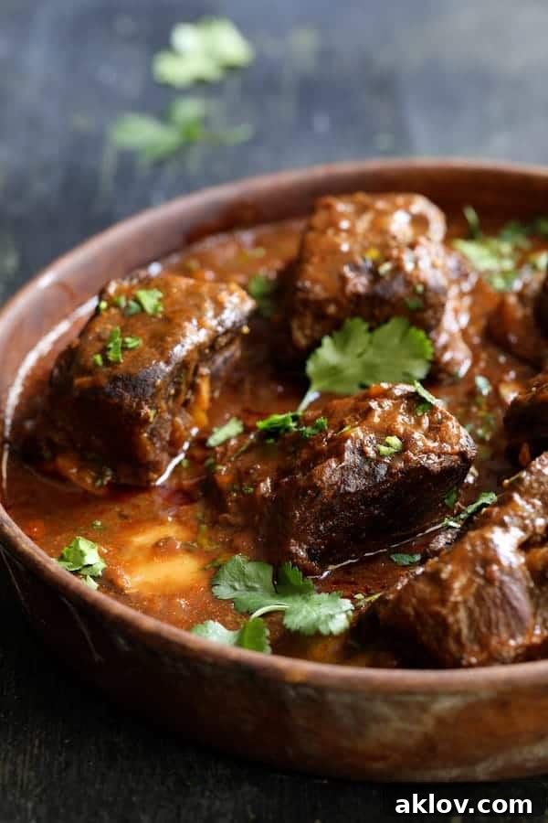 Close-up view of a whole Slow Cooker Beef Short Rib Barbacoa resting on a bed of Cilantro Lime Cauliflower Rice, elegantly garnished.