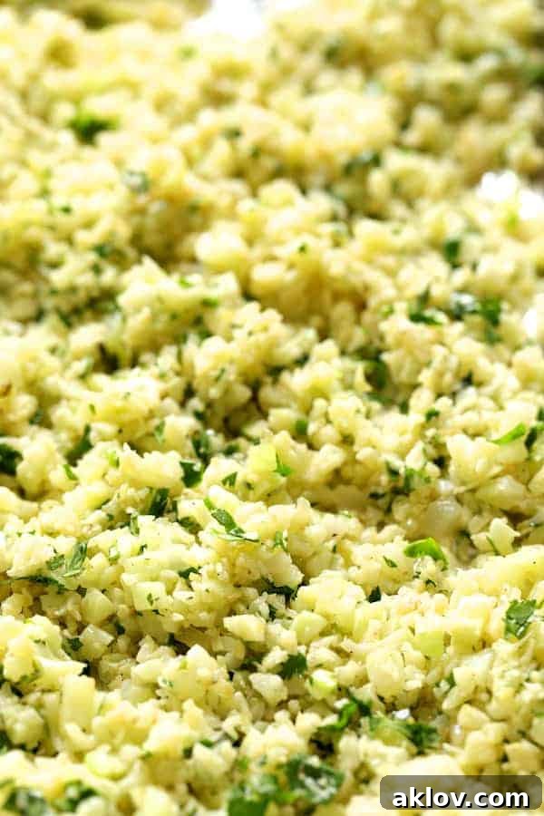 Close-up of vibrant Cilantro Lime Cauliflower Rice perfectly roasted on a sheet pan, ready to be served.