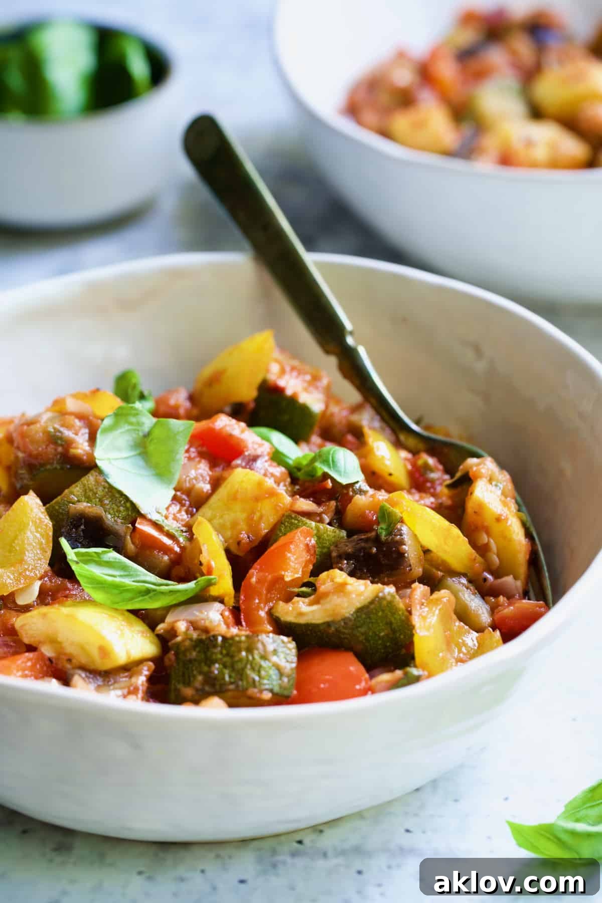 One serving of Classic French Ratatouille in white bowl with fork.