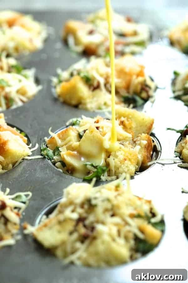 Photo of unbaked stratas in a muffin pan with the egg and milk custard being poured over the bread mixture.