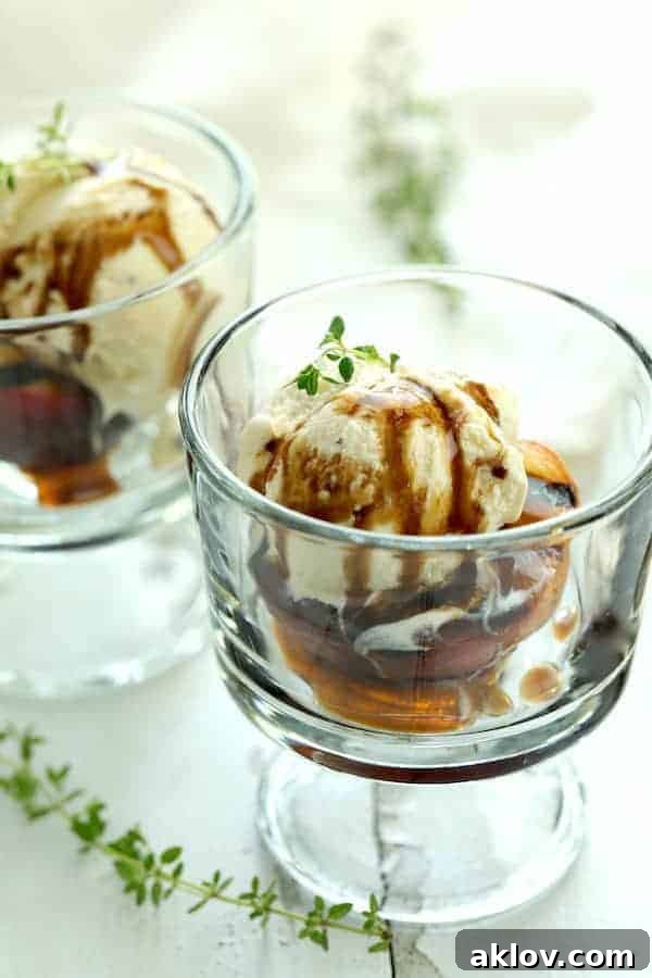 Photo of Grilled Peaches with Vanilla Ice Cream and Honey Balsamic Drizzle in glass serving dish garnished with fresh thyme.
