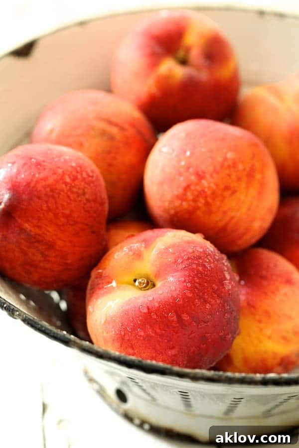 Close-up photo of freshly washed peaches.