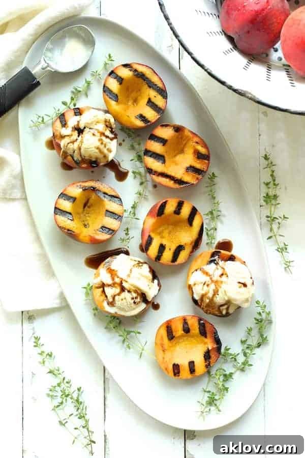 Photo of Grilled Peaches with Vanilla Ice Cream and Honey Balsamic Drizzle garnished with fresh thyme.