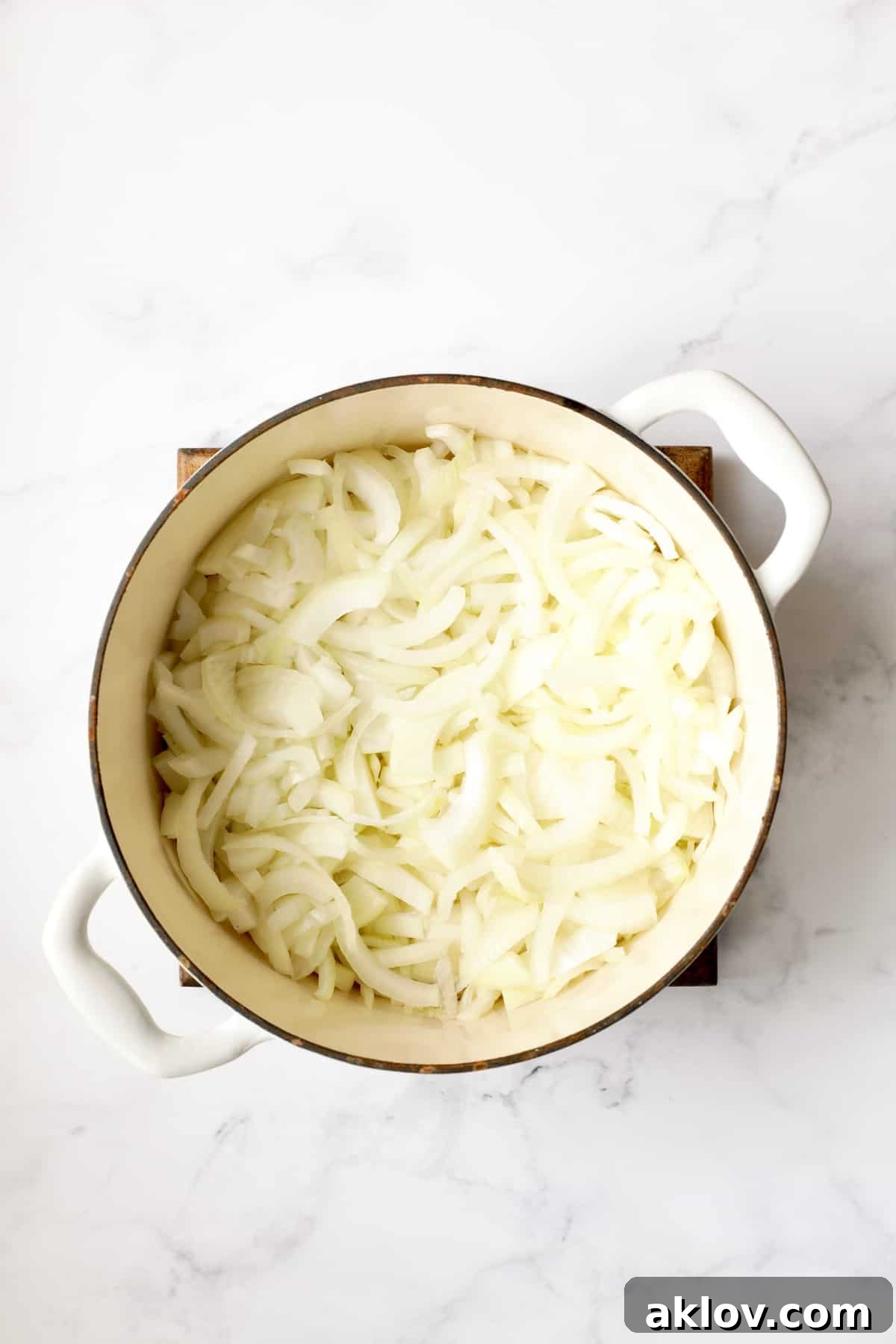 Date Night French Onion Indulgence 5 Photo of sliced onions in white Dutch oven.