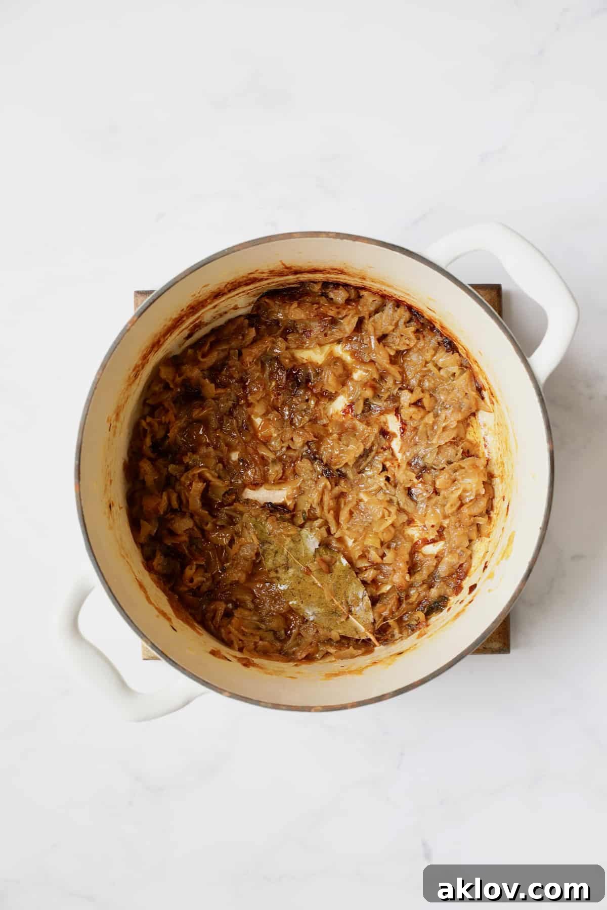 Date Night French Onion Indulgence 7 Photo of caramelized onions in white Dutch oven.