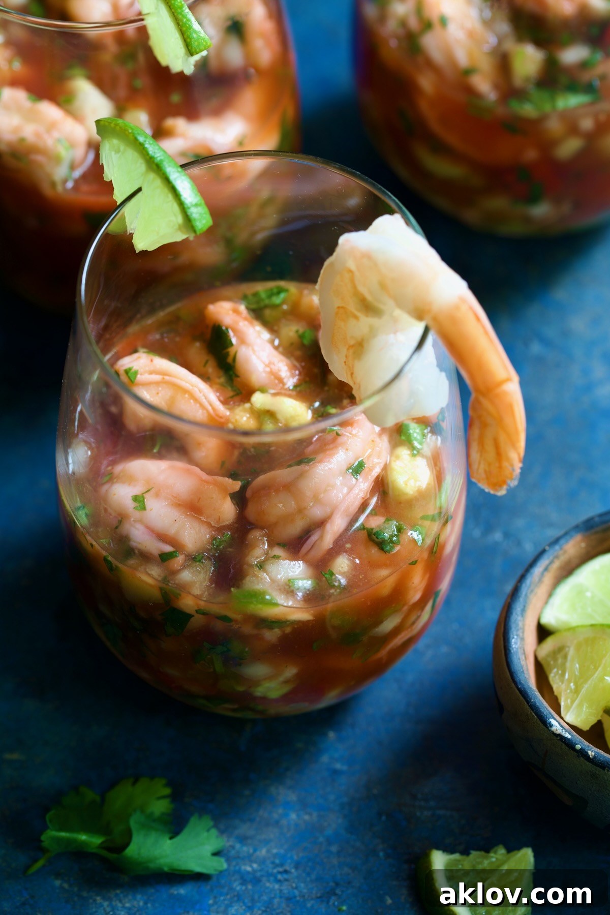 Mexican Shrimp Cocktail in glass garnished with lime wedge and shrimp.