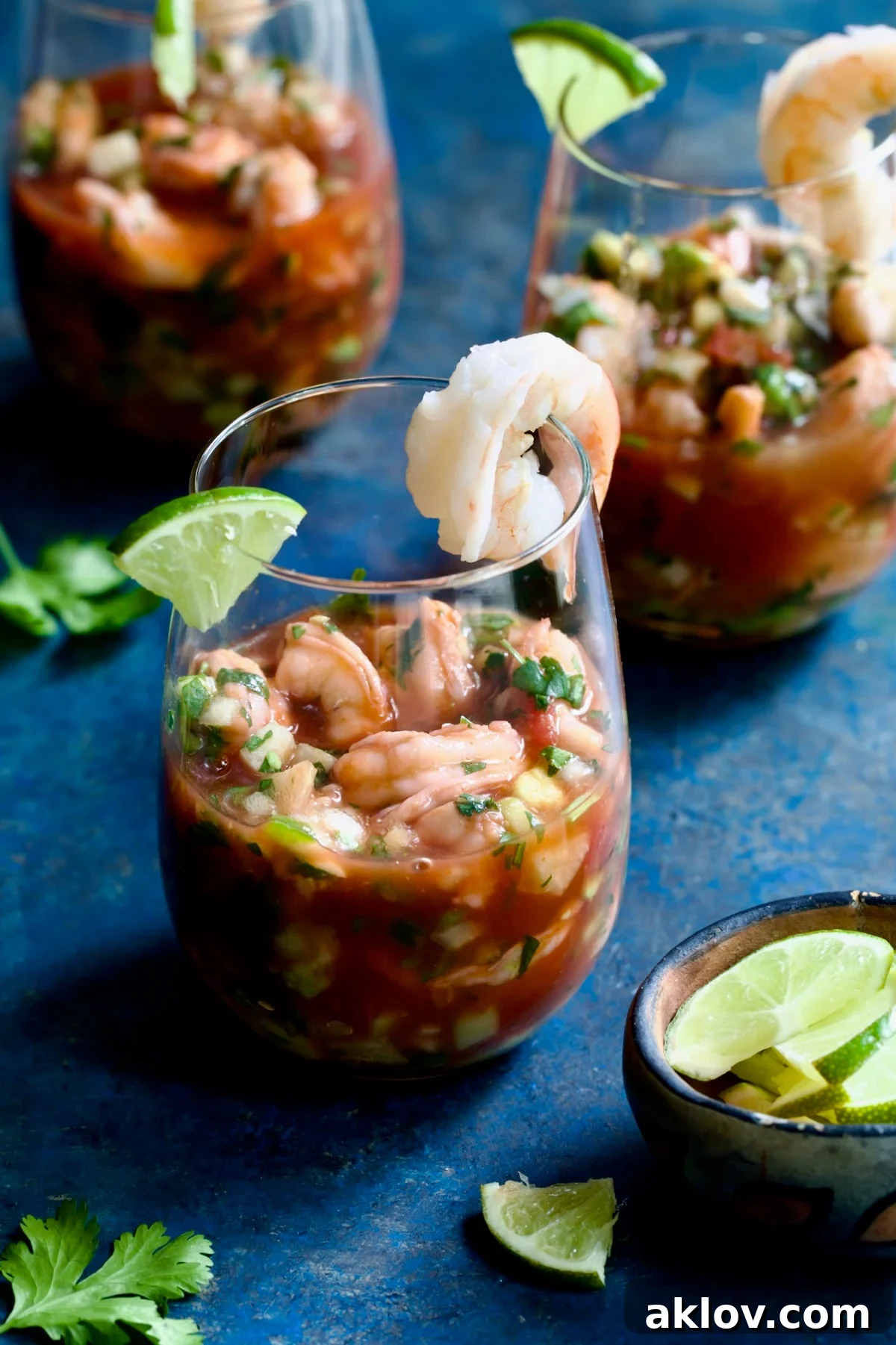 Three beautifully presented glasses of Mexican Shrimp Cocktail, inviting and colorful.