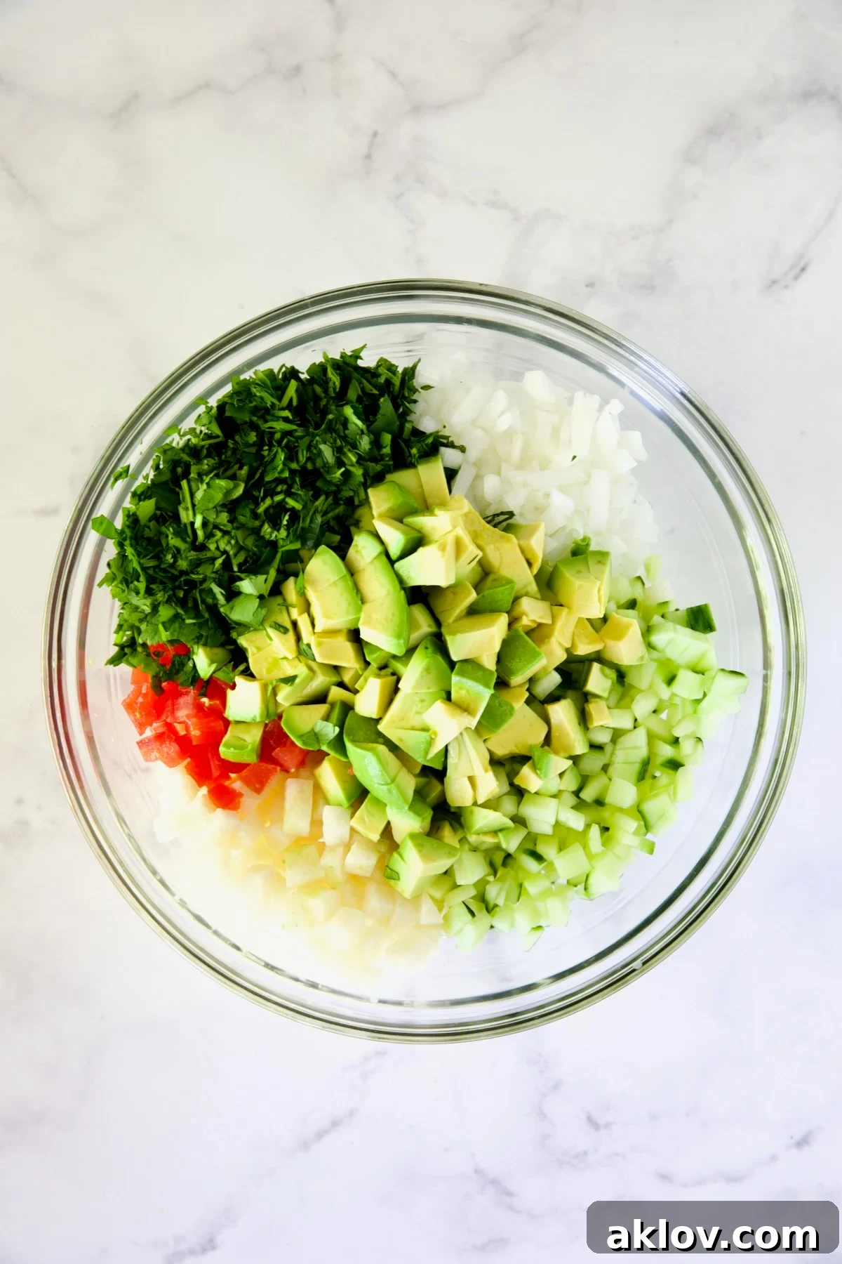 A colorful array of diced vegetables for the shrimp cocktail, awaiting their mix.