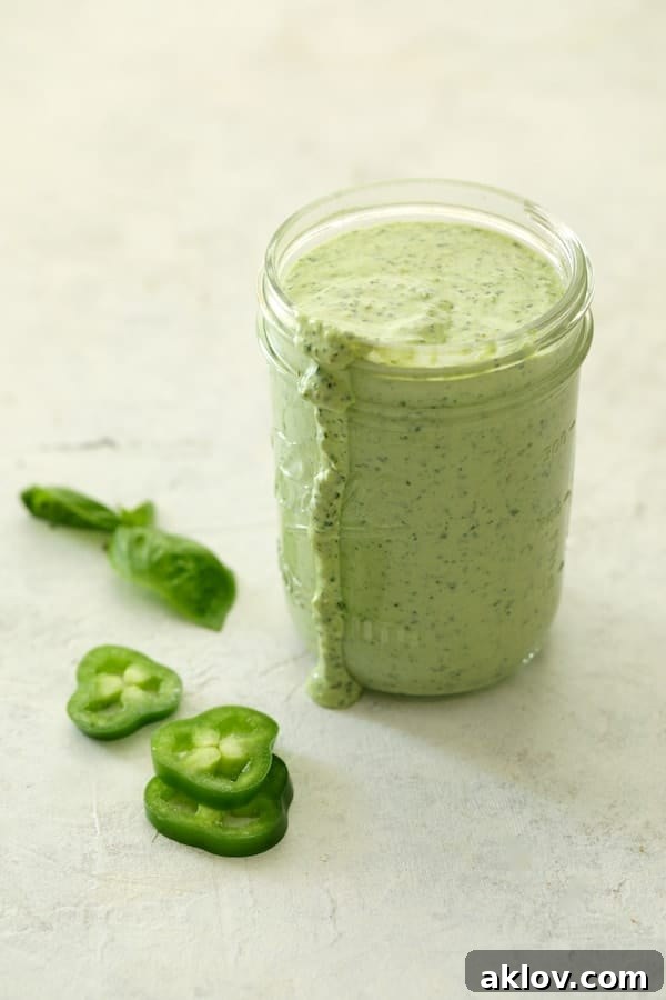 Photo of the freshly prepared Spicy Pesto Aioli, a vibrant green, served in a charming glass jar, ready for dipping.