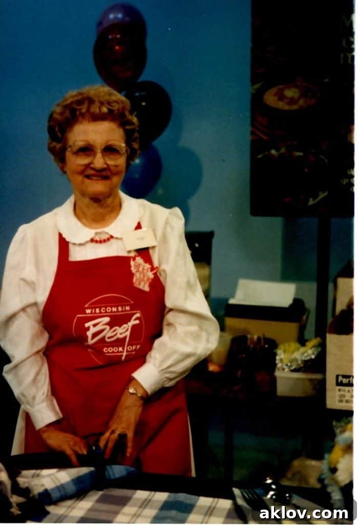 Photo of woman in red apron at beef cooking contest.