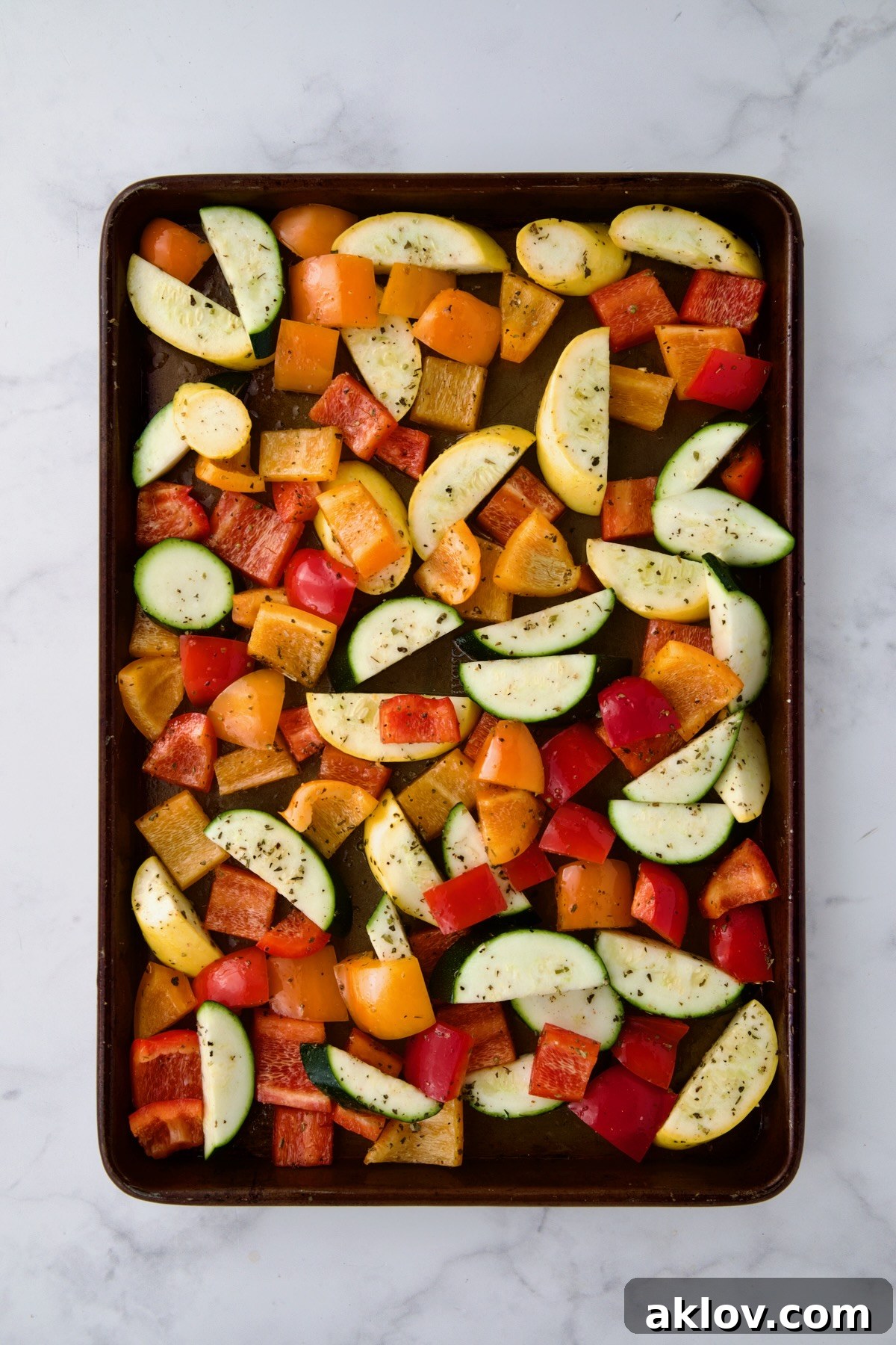 Uncooked vegetables on rimmed sheet pan.