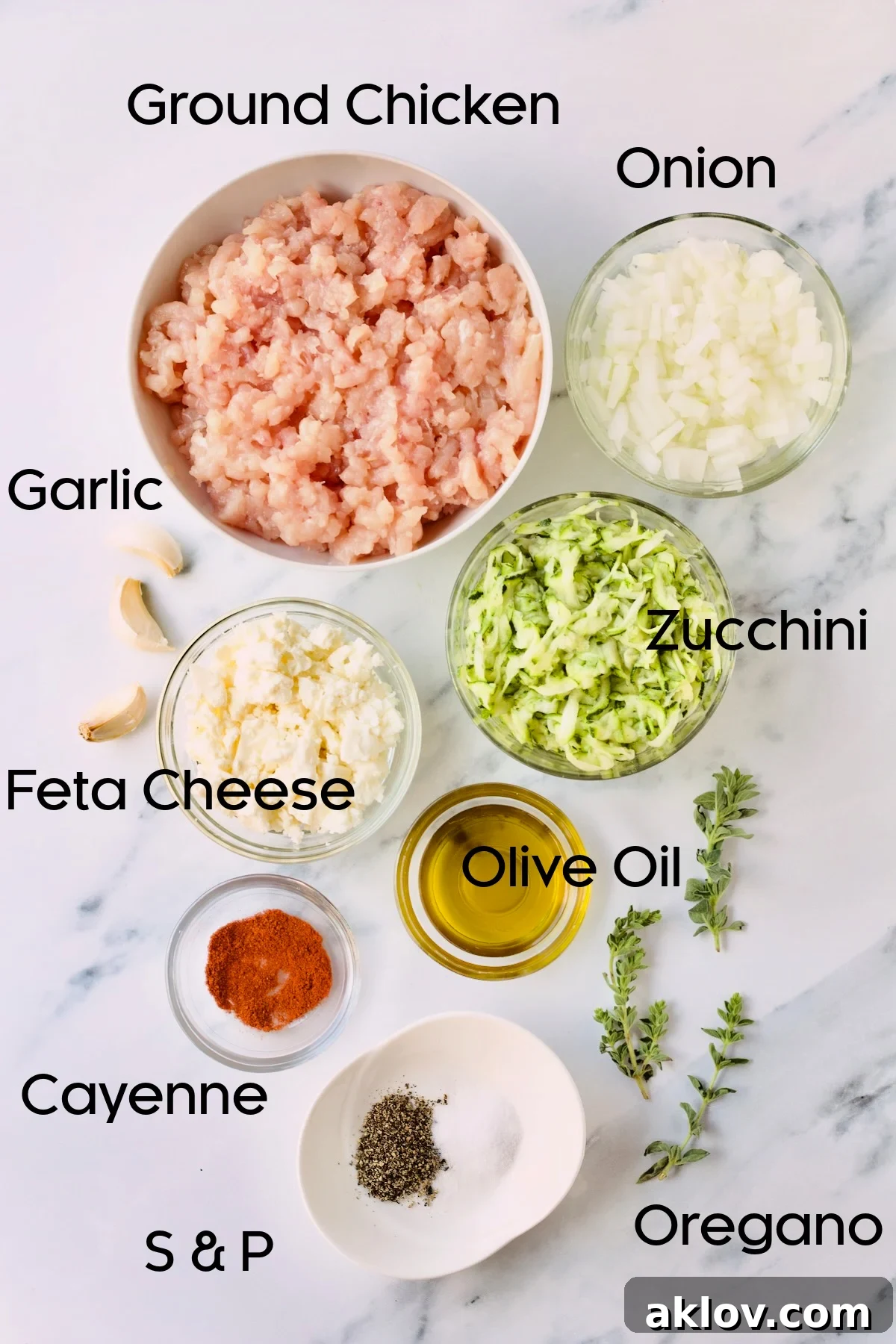 Bowls of fresh ingredients for ground chicken burgers arranged neatly on a kitchen countertop, ready for preparation.